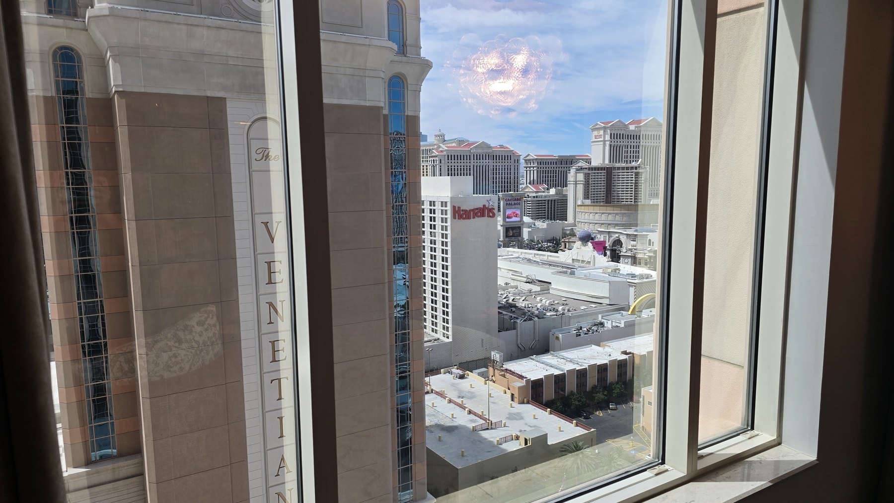 The Venetian's own tower on the left, Harrah's and the Sphere visible to the right, seen from the window of Room 21133
